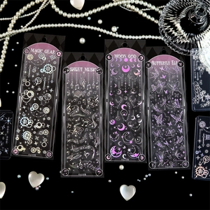 Close-up of laser holographic silver stickers with gears and butterfly motifs on dark background