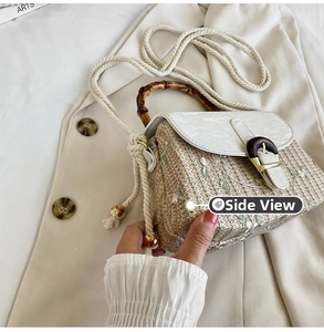 Detail of straw woven bag featuring bamboo handle, white flap, and rope strap