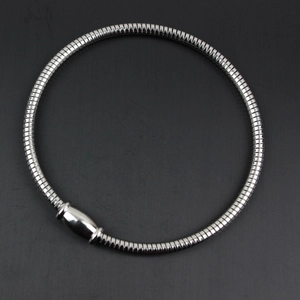 Detail of silver stainless steel snake chain bracelet with polished magnetic clasp closure