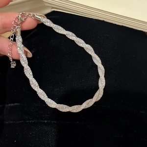 Macro detail of silver glitter mesh bracelet with adjustable lobster claw clasp closure