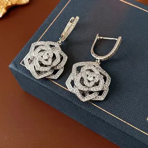 Silver hollow rose drop earrings with zircon micro-paving and luxury modern floral design