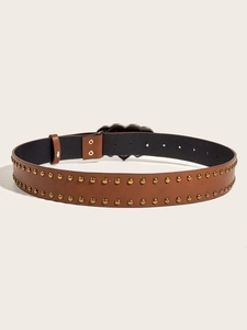 Detail of brown leather belt with heart-shaped buckle and double rows of gold studs