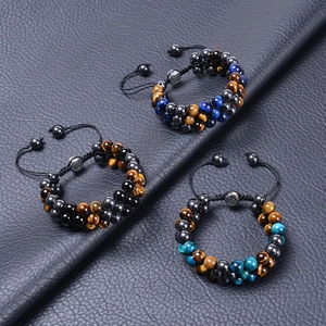 Macro detail of 8mm natural tiger eye stone beads on adjustable braided bracelets