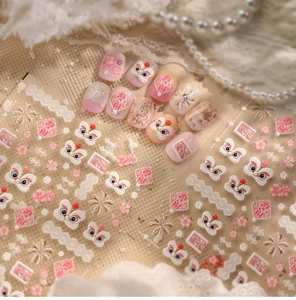 Macro shot of 3D embossed pink lion dance nail art stickers with golden floral details
