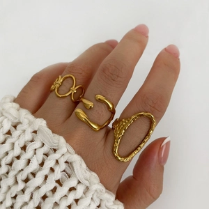 Set of three textured 18K gold plated titanium steel rings on model hand