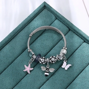 Silver steel wire bangle with pink enamel starfish, bee and butterfly charms