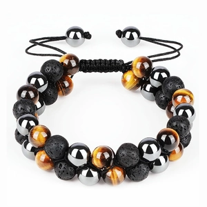 Macro detail of braided double-layer bracelet with tiger eye stones and hematite beads