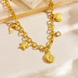 Golden chunky chain necklace with ocean-themed starfish, shell, and dolphin charms