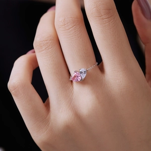 Detail of adjustable chain ring featuring pink and clear heart-shaped cubic zirconia