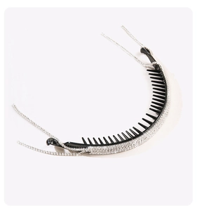 Detail of black hair twist clip with sparkling rhinestones and dangling fringe chains