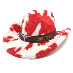 Detail of red and white cow print cowboy hat with metallic bull emblem and leather strap