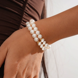 Detail of elegant double-layer faux pearl bracelet with sparkling rhinestone accents
