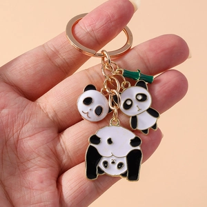 Panda keychain with bamboo charms in gold metal and black white enamel finish