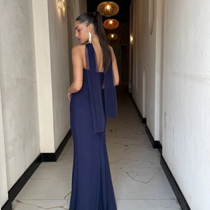 Detail of elegant back drape and trailing ribbon on dark blue slim evening dress
