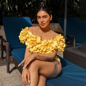 Detail of 3D yellow floral appliqué on strapless swimsuit with vibrant texture