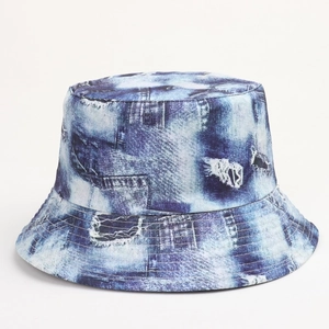 Close-up of retro 90s bucket hat featuring distressed denim print and bleach tie-dye detail