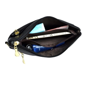 Internal view of black pebble leather crossbody bag with multiple zipper compartments