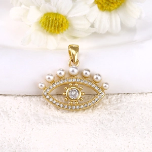 Detailed close-up of a gold-plated evil eye pendant with pearls and cubic zirconia