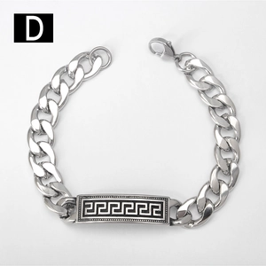 Detail of silver Cuban chain bracelet with black Greek Key engraved plate and lobster clasp