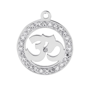 Macro detail of silver stainless steel Om pendant with sparkling cubic zirconia border