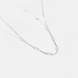 Detailed view of handmade S925 sterling silver chain with elegant white round pearls