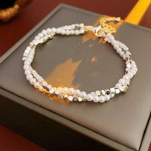 Detail of double-layer pearl and silver square bead bracelet on jewelry box