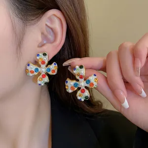 Exquisite flower clip earrings with colorful rhinestones and pearls on elegant model