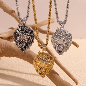 Crowned lion head pendants in gold and silver finish with rhinestones on a wooden branch