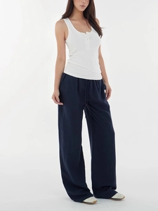 Women's chic white tank top and deep blue wide-leg trousers in a casual minimalist style