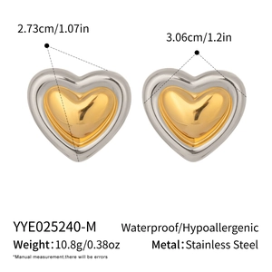 Detail showing two-tone heart earrings with size measurements of 2.73cm by 3.06cm