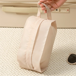 Close-up of portable travel underwear organizer bag with wide handle in light beige