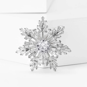 Detailed close-up of a luxury snowflake brooch with sparkling cubic zirconia on silver metal