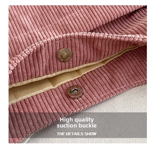Detail of high-quality magnetic metal clasp on vintage pink corduroy bucket bag