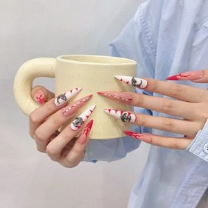 Handmade stiletto press-on nails with red flame patterns and metal moon charms
