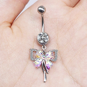 Detailed shot of silver belly ring featuring iridescent butterfly wings and crystal bow charm