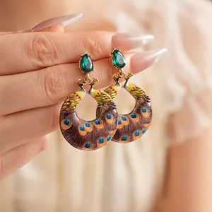 Vintage peacock earrings featuring green pear-cut crystal and colorful feather patterns