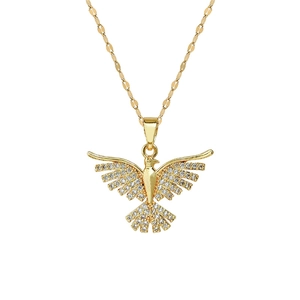 Detailed macro view of a gold phoenix necklace pendant set with sparkling zircons