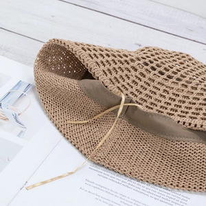 Breathable hollow straw bucket hat for women with bow strap and sun protection in khaki