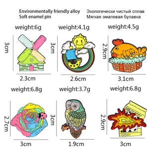 Creative enamel pins set featuring windmill, rainbow boat, and owl in eco-alloy