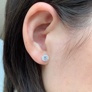 Elegant S925 sterling silver stud earring with clear zircon inlay worn by a female model