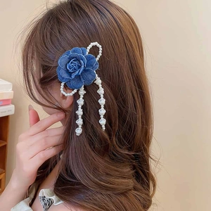 Detail of blue denim fabric rose hair clip with white pearl tassels and fringe