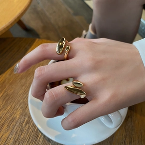 Minimalist irregular gold plated open rings featuring a glossy organic droplet design