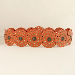 Detail view of vintage camel suede PU belt with bronze rivets and circular leather pieces