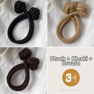 Detail of high-elastic double-knot hair ties in black, khaki, and brown, 3-piece set