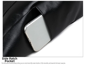 Close-up of the side pocket on a black soft leather tote bag holding a white smartphone