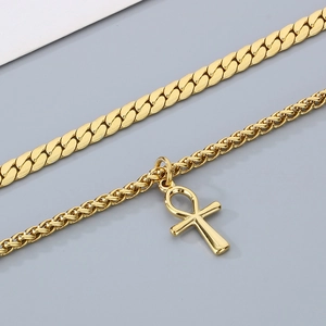 Double layered gold stainless steel necklace featuring Cuban chain and Ankh cross pendant