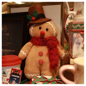 Detail of Christmas gingerbread plush with top hat, red scarf and wavy trimmings