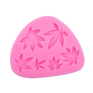Detail of pink silicone mold featuring six different maple leaf shapes with clear textures