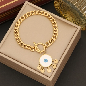 Golden Evil Eye bracelet with T-bar clasp and blue charms on a jewelry box