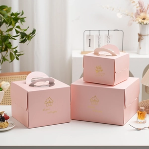 Set of three pink square cake boxes with gold foil text, handles and clear windows